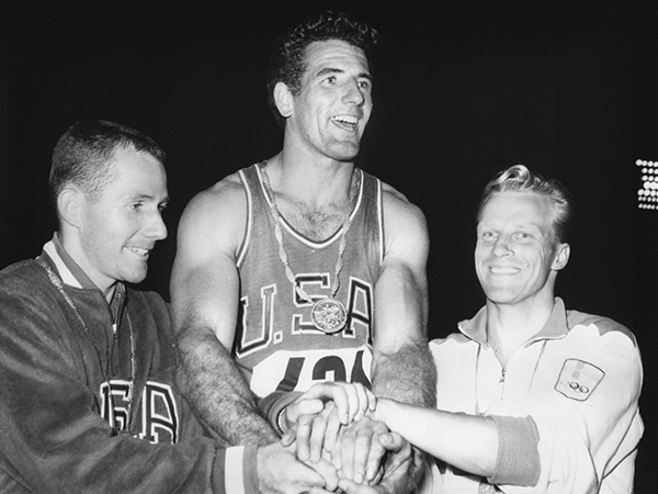 Don Bragg, center, celebrates his Olympic gold medal win flanked by Ron Morris (left) and Eeles Landstrom (right), silver and bronze medal winners, respectively. 